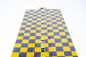 Panoramic view of the new residential building. Bright facade of the house of panels. The facade design is a chessboard. Modern apartment building with an unusual design photo