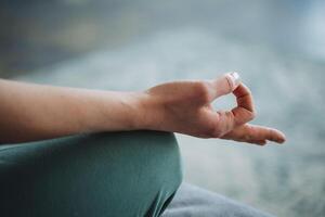 Meditation hand close-up, fingers fold the rite of mudra, yoga practice. Peace of mind, peace, love yourself, take care of your health. photo