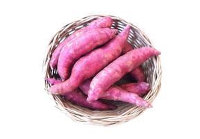 Organic sweet potatoes on basket, white background. Concept, agriculture crops. Food ingredient for cooking dessert, delicious and good for health, can be cooked for variety menu. photo