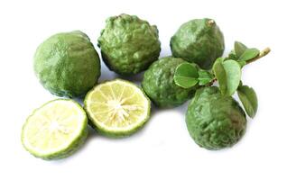 Bergamot fruits and leaves on white background. Concept, herbal fruits with sour taste, can be cooked as food seasoning and use for spa , aromatherapy. Hair treatment photo