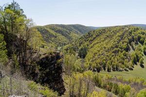 Tract Bujatau Bashkortostan Russia, nature landscape, green forest, valley, sunny weather. the stone protrudes on the rock. photo