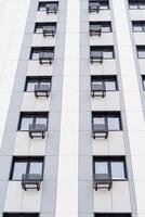 Modern apartment building in the city. Fiber cement panels for cladding the facade. Air conditioning is in each apartment. Frame with perspective. photo