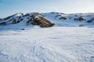 The mountains are covered with snow landscape winter, hiking in the mountains in winter, hills under the snow, the beauty of nature, morning dawn. photo