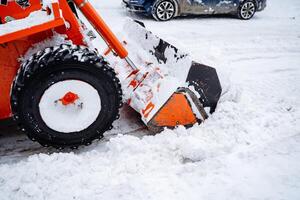 Large snowdrifts in the city. Clearing snow debris. Snow removal on city streets. Utilities. Clean the snow. A large snowdrift is piled up. photo