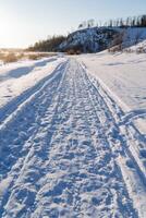 invierno nieve la carretera. motonieve huellas naturaleza. foto