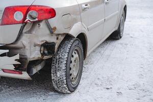 A close-up of the wing of the car was broken at the rear. Missing rear bumper car after an accident on the road, winter in the city. photo