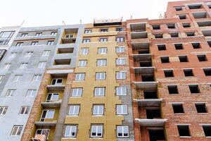 Panoramic view of newly built house. . Stage of construction of the house. Facade cladding with insulation material. photo