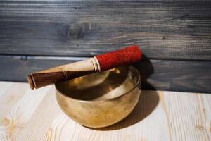 A Tibetan singing bowl on the floor. A subject for meditation and healing sounds. Zen practice.Calm and tranquillity photo