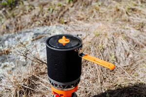 Quick cooking system, quick boiling pot, pot with handle, neoprene cover, camping food, compact gas burner. photo