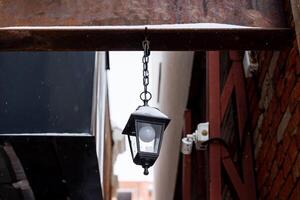 Street lamp on the beam. Vintage street lamp. Cityscape. Night lighting in dark alleys photo