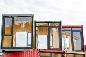 PVC windows, panoramic window of the top floor, construction of a fashionable cafe, sea containers converted into a store, large glass frame aluminum. photo