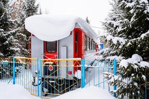 The train stands on the alternate track wintering under the snow. winter photography of the cityscape. The transport was stuck in a deep snowdrift. photo