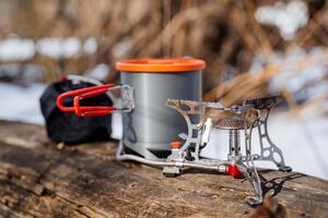 Camping gear, camping utensils, gas burner, outdoor cooking, ultra light equipment, traveling in the woods. photo