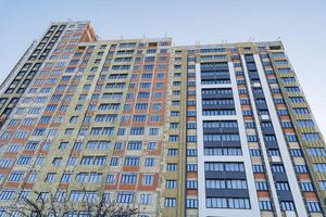 View of the construction of the house from the street, the building of the apartment building is insulated from the outside, the protection of the walls is thermal insulation with mineral wool photo