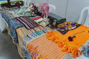 Exhibition of folk art objects. Handmade embroidery patterns on fabric. Carpets are made on a loom. Craft photo