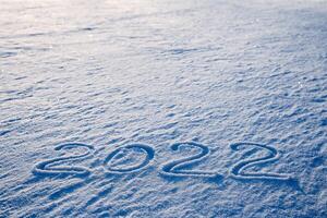 2022 inscription on the snow. The numbers of the year are written in the snow. Date two thousand twenty-two. Year of the Tiger. ice lake. photo