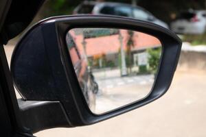 Side rear view mirror with fungus on a car. A fungus growing in the mirror on a car. photo