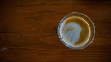 hot latte with latte art in wooden background photo