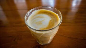 hot latte with latte art in wooden background photo