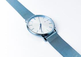 Close up blue metal stainless steel hand watch. Object photography isolated on white studio background. photo