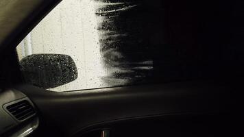 The car wash brush washes the side window of the car video