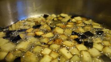 diced aubergines with a little salt that fry in a saucepan video