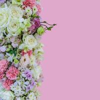 Beautiful bouquet flowers with different types of colorful flowers on pink background photo