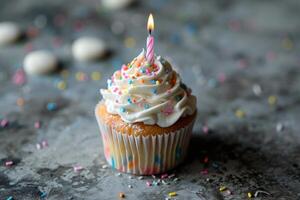 AI generated Colorful birthday cupcake with candle on gray background. photo