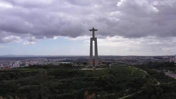 ALMADA, PORTUGAL - MARCH 2, 2023. Cristo Rei Statue and Almada City, Portugal. Christ the King Statue. Orbiting video