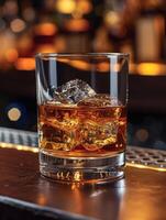 AI generated Glass of whiskey with ice cubes on the wooden bar counter photo