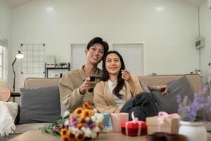 Asian couple lifestyle, man and woman watch TV movie at home, family lifestyle relax and recreation concept. fall in love. Valentine concept photo