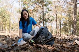 Separating waste to freshen the problem of environmental pollution and global warming, plastic waste, care for nature. Volunteer concept carrying garbage bags collecting the garbage photo