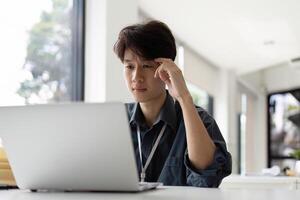 Thinking and stress Asian office employee feeling bored and tired, unhappy and burnout working in office photo