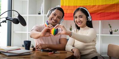 Asian gay radio host enjoy chatting while record an audio podcast with female friend photo