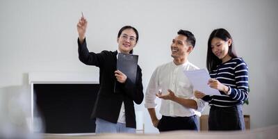 Real estate agent giving buy or tenant tour about big new house. Couple or husband and wife who plan property investment looking at home photo