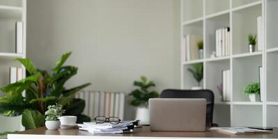 Empty workplace with desk and plant in office room, copy space. work from an atmospheric home office full of green plant photo