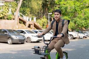 The businessman eco friendly transportation, cycling through the city avenues to go to work. sustainable lifestyle concept photo