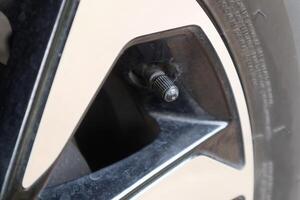 A tire valve on the car wheel photo
