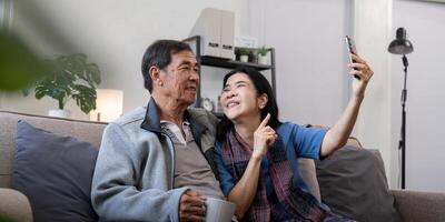 Happy old couple elderly taking selfie on cellphone, senior mature spouses wife and husband laughing holding phone make self portrait on smartphone camera photo