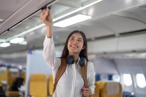 Alone Asian woman passenger traveling by plane. happy traveler on board. Solo travel concept photo