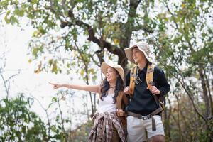 Lovely couple lesbian woman with backpack hiking in nature. Loving LGBT romantic moment in mountains photo