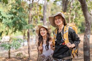 Lovely couple lesbian woman with backpack hiking in nature. Loving LGBT romantic moment in mountains photo