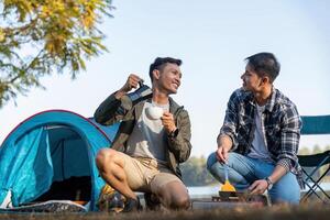 contento asiático masculino gay Pareja en cámping juntos en un bosque. romántico vocación viaje. lgbt concepto foto