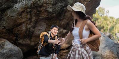 Lovely couple lesbian woman with backpack hiking in nature. Loving LGBT romantic moment in mountains photo