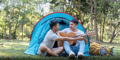 Male gay couple asian traveling with tent camping outdoor and various adventure lifestyle hiking active summer vacation photo