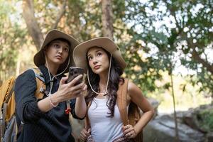 Lovely couple lesbian woman with backpack hiking in nature. Loving LGBT romantic moment in mountains photo