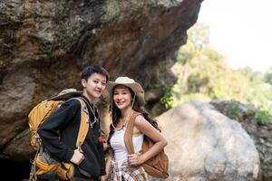 Lovely couple lesbian woman with backpack hiking in nature. Loving LGBT romantic moment in mountains photo