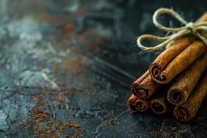 AI generated Cinnamon sticks on a dark textured background with copy space photo