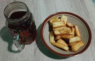 Breakfast menu, fried cassava, and hot sweet tea photo