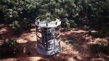 A futuristic glass greenhouse tower in the middle of a lush forest video